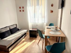 a living room with a couch and a table at Apartmány Polná na Šumavě in Svíba