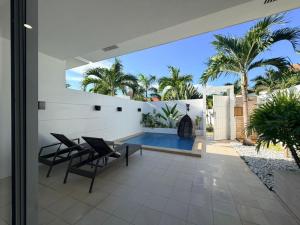 an outdoor patio with chairs and a swimming pool at Pineale Villas, Resort and Spa in Panglao Island