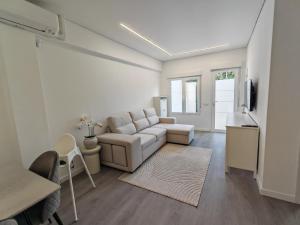 a living room with a couch and a table at La Romanilla Garden terrace in Roquetas de Mar