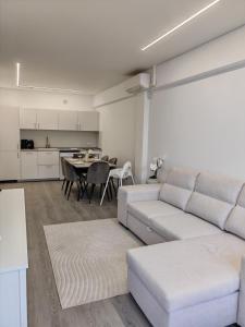 a living room with a couch and a table at La Romanilla Garden terrace in Roquetas de Mar +15 photos