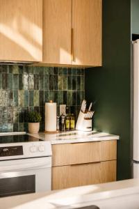 a kitchen with a white stove and green tiles at Spa & Lake - Orphee in Chertsey +33 photos