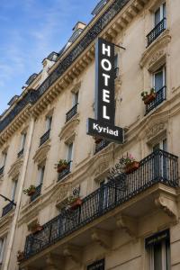 a hotel sign on the side of a building at Kyriad Hotel XIII Italie Gobelins in Paris