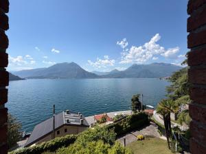a view of a large body of water with mountains at Villa 64 in Fiumelatte