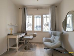 a room with a chair and a desk and a mirror at Chic apart with parking and balcony in Yaoundé