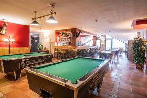 a billiard room with two pool tables and a bar at Hotel Ransol in El Tarter