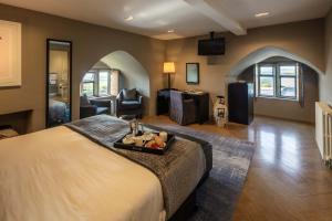 a bedroom with a large bed and a living room at Roch Castle in Roch
