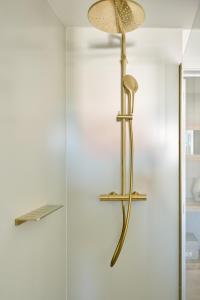 a gold floor lamp hanging on a wall at Lebeaubylivingroom Hotel in Knokke-Heist +128 photos