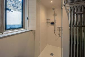 a bathroom with a shower with a glass door at Roch Castle in Roch +71 photos