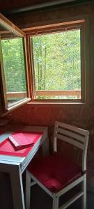 a room with a table and a chair and a window at Chalet de la Grave in LʼEscarène