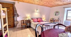 a bedroom with a bed and a wooden ceiling at Chambre d'hôtes L'Adrienne in Chazeaux