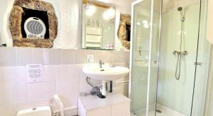 a bathroom with a sink and a shower at Chambre d'hôtes L'Adrienne in Chazeaux