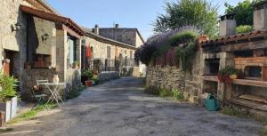 an alley in a village with stone buildings at Chambre d'hôtes L'Adrienne in Chazeaux