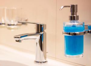 a glass bottle of soap is sitting on a bathroom sink at Haus Gant in Sankt Gallenkirch +89 photos