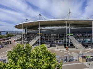 a large building with stairs in a parking lot at Novotel Suites Paris Stade de France in Saint-Denis