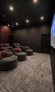 a room with couches and a flat screen tv at Excel Grand Stays in Frisco