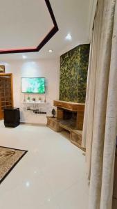 a large living room with a television on the wall at Cozy Central Studio in Ifrane in Ifrane