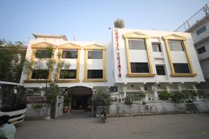 a bus parked in front of a building at Hotel Sujata in Bodh Gaya
