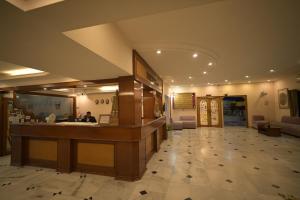 a hotel lobby with a reception desk and a mirror at Hotel Sujata in Bodh Gaya