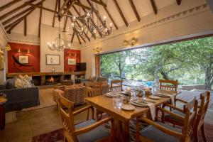 a dining room with a table and chairs at Shimungwe Lodge, Thornybush Game Reserve in Hoedspruit