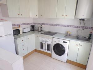 a kitchen with a washing machine and a sink at Camposol House in Mazarrón +6 photos