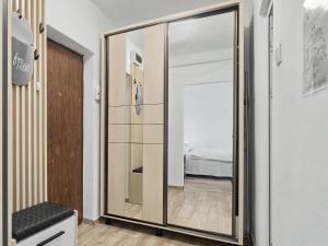 a large mirror in a room with a bedroom at Konstanzer12 - Free Parking Apt - AC in Iaşi