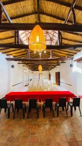 a large room with a large red table and chairs at Casa de ejercicios zaxue colonial in Zapatoca