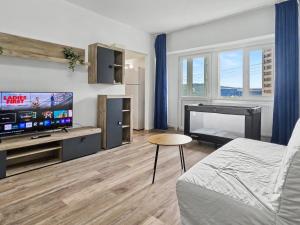 a living room with a bed and a flat screen tv at Konstanzer12 - Free Parking Apt - AC in Iaşi