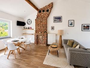 a living room with a couch and a table at Station 33 in Spa