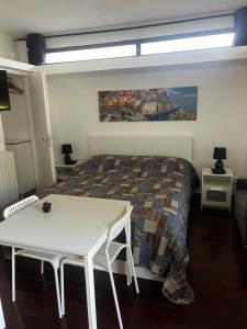 a bedroom with a bed and a table with a bed gmaxwell gmaxwell gmaxwell at Studio Natalie in Marina di Massa +49 photos