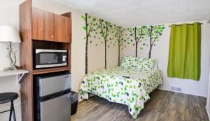 a small bedroom with a bed and a tv at Whitehall Cottages in Whitehall