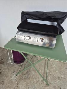 a green table with two boxes on top of it at PLAIN PIED, avec mezzanine et espace extérieur 10min Puy du F in Les Herbiers