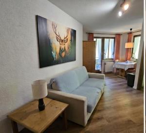 a living room with a couch and a table at FeWo Schwarzwaldglück Todtmoos mit Sauna, Tischtennis, Fitness, Stellplätzen in Todtmoos
