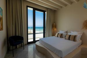 a bedroom with a bed and a view of the ocean at Diar Ayoub in Chebba