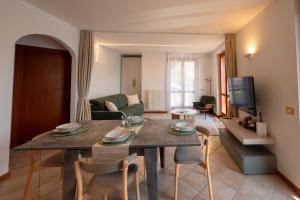 a living room with a table and chairs and a couch at Lake Iseo Panorama Suite in Tavernola Bergamasca