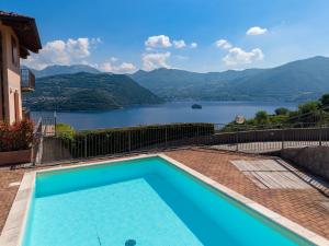 a swimming pool with a view of a lake at Lake Iseo Panorama Suite in Tavernola Bergamasca
