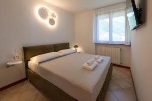 a bedroom with a bed with a teddy bear on it at Lake Iseo Panorama Suite in Tavernola Bergamasca