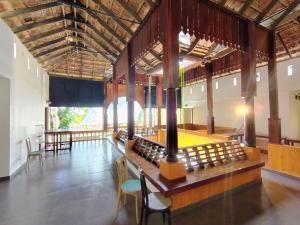 a large room with chairs and tables in a building at Samudra heritage in Cochin