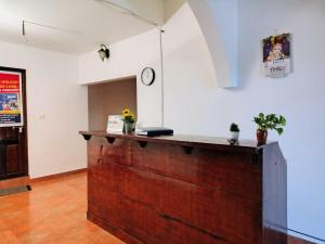 a counter in a room with a clock on the wall at Samudra heritage in Cochin