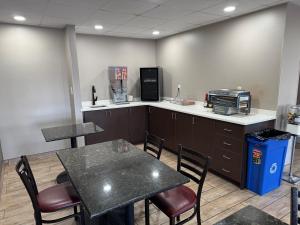 an office with a table and chairs and a counter at Super 8 by Wyndham Conway in Conway