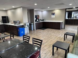 an empty waiting room with tables and chairs at Super 8 by Wyndham Conway in Conway +5 photos