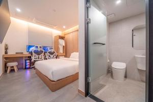 a bedroom with a bed and a bathroom with a toilet at Giverny Hotel in Gyeongju +83 photos
