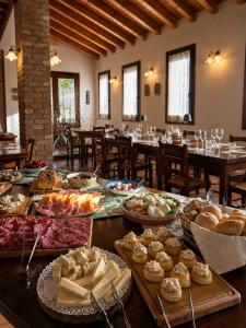 a table with many different types of food on it at Agriturismo Le Cipressine in Meolo