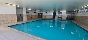 a large blue swimming pool in a building at Hibernian Towers 307 in Strand