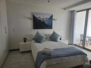 a bedroom with a large bed and a large window at Hibernian Towers 307 in Strand