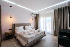 a bedroom with a bed with towels on it at Orizon Apartments in Limenas