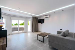 a living room with a couch and a tv at Orizon Apartments in Limenas