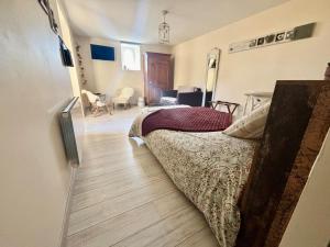 a bedroom with a bed and a wooden floor at Aux 4 Cornes - Chambres d'hôtes et Gite in Longeves +78 photos