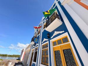 a blue and white building with a balcony at Imperialis Boutique Hotel in Canavieiras