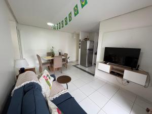 a living room with a couch and a tv at Apartment in Ponta Negra in Manaus