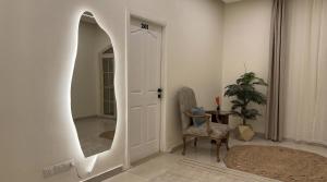 a hallway with a mirror and a chair and a table at Villa Golden Sunset Pyramids in Cairo +102 photos
